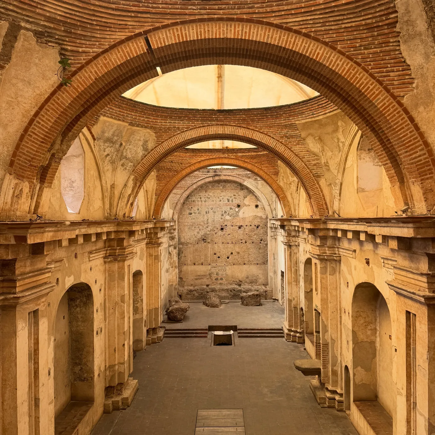 An ochre arched cloister in ruins, Antigua
