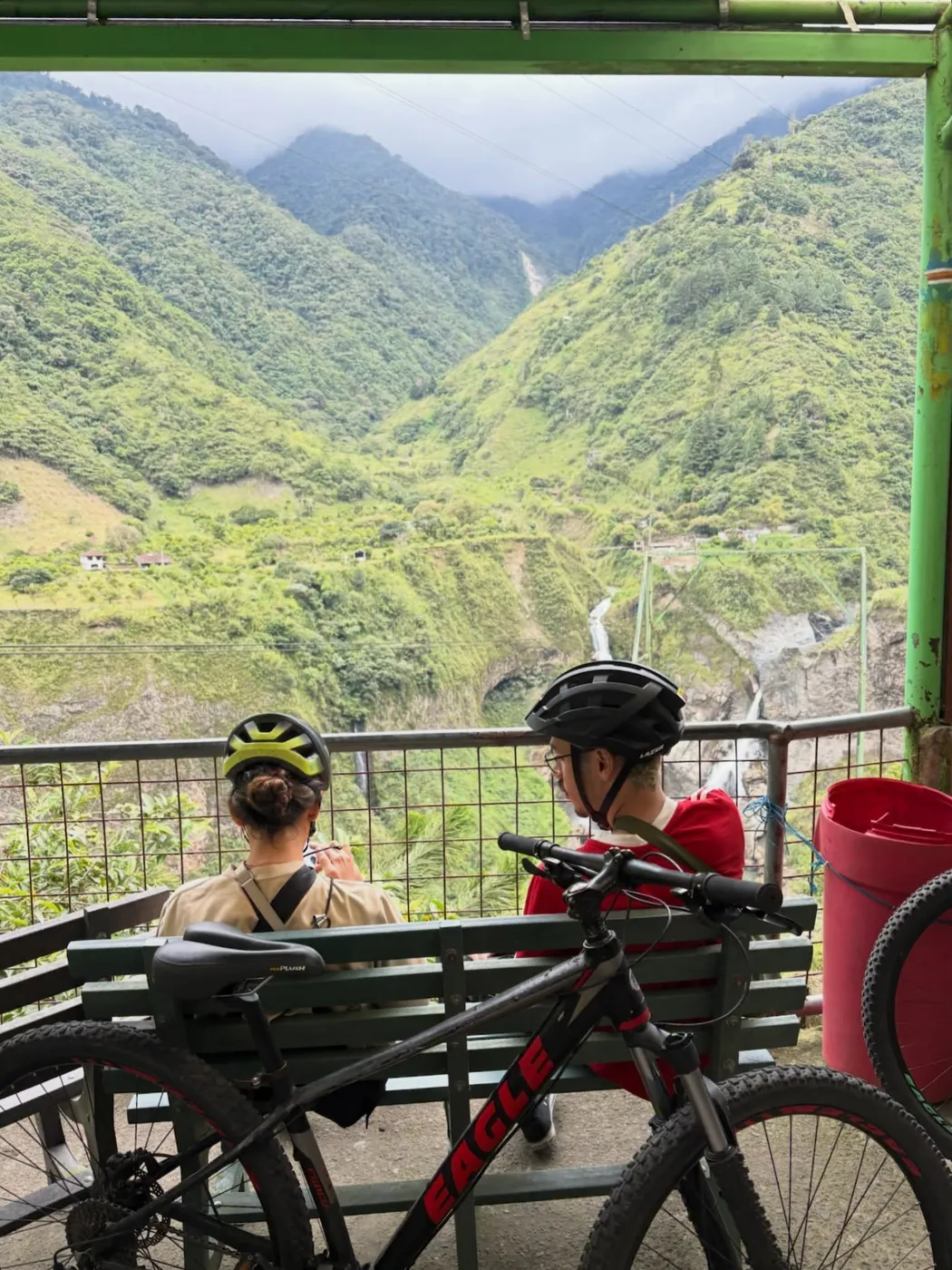 Two cyclists by a green valley, Baños