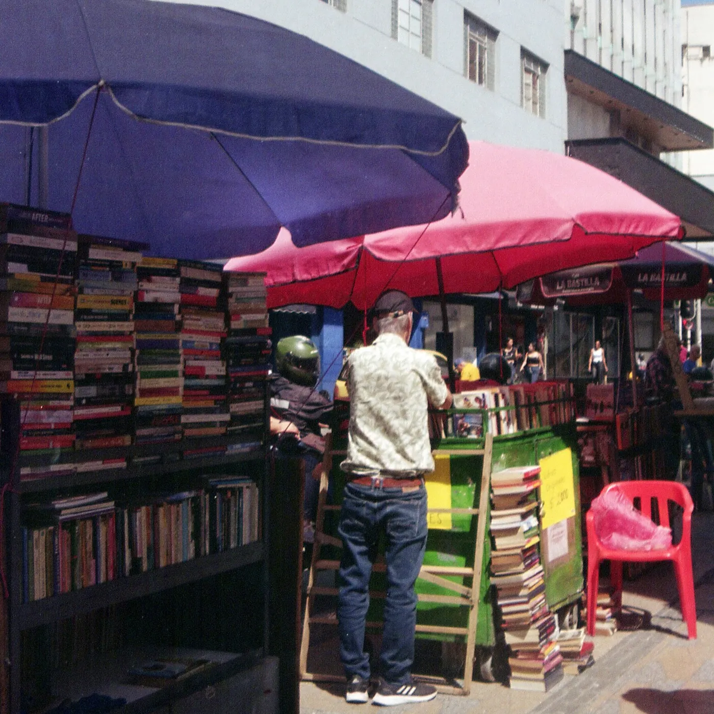Book stalls under pink and purple umbrellas, Colombia