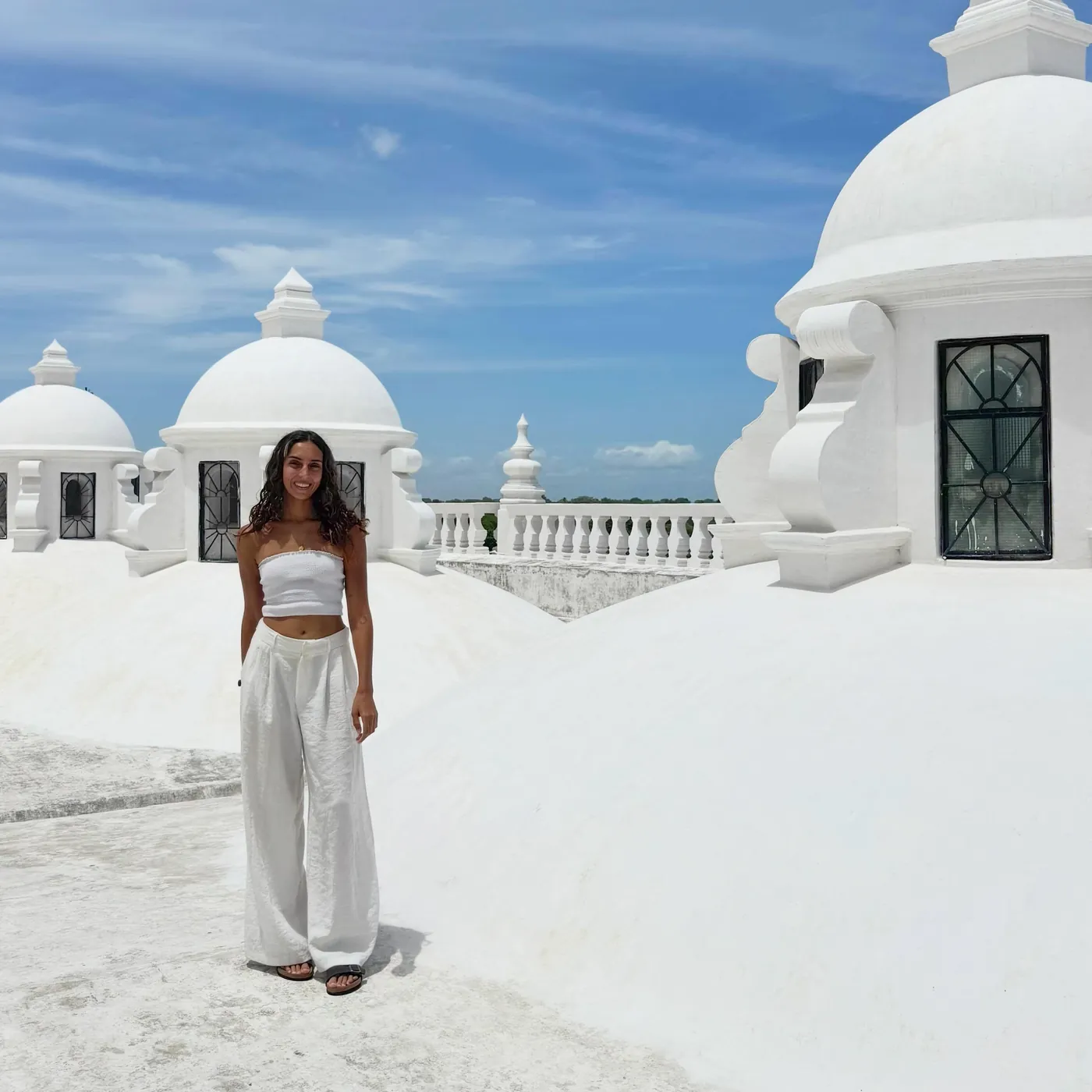 Natasha in white on the white cathedral roof, León