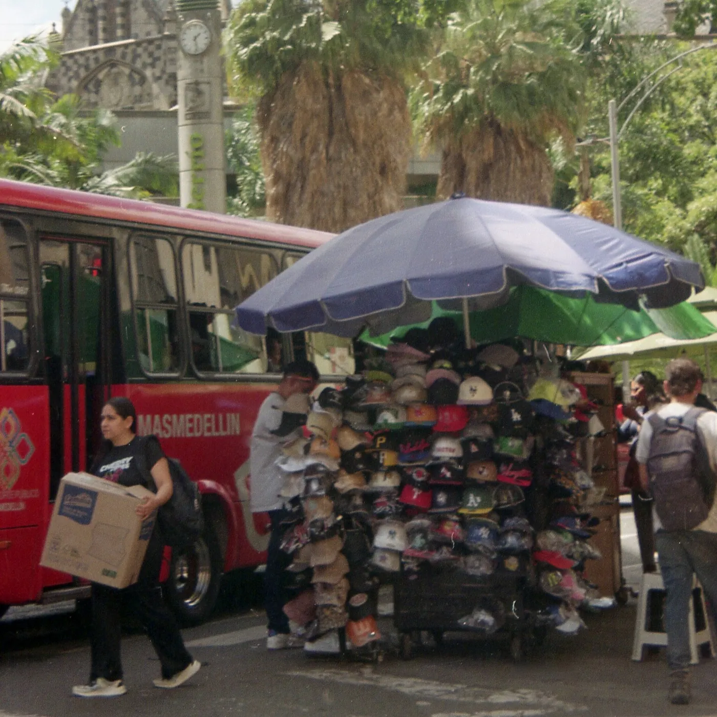 A red bus and a hat stall in the street, Colombia